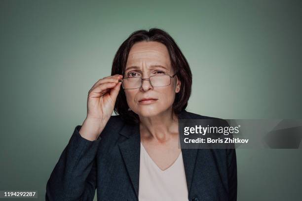 sceptic businesswoman - suspicion stock pictures, royalty-free photos & images