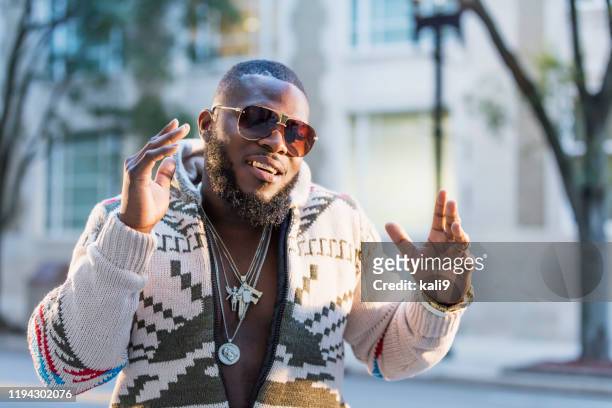 afroamerikanischer mann mit goldgrill auf der stadtstraße - capped tooth stock-fotos und bilder