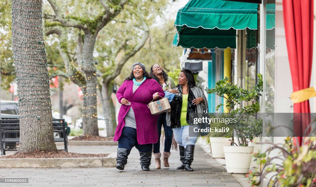 Três mulheres afro-americanas que andam na cidade
