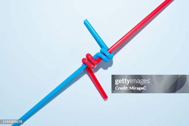 two twisted drinking straws - intertwined photos et images de collection