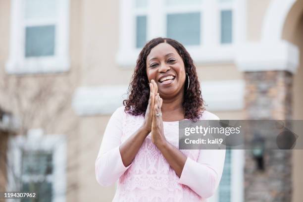 mature woman standing in front of house - person in front of house stock pictures, royalty-free photos & images