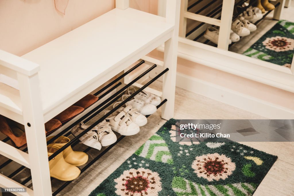 Shoe rack with different size shoes showing the concept of family