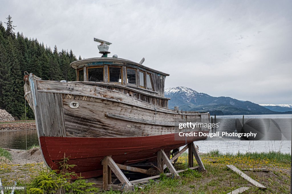 Old Wooden Fishing Boat Sitting In A Cradle High-Res Stock Photo