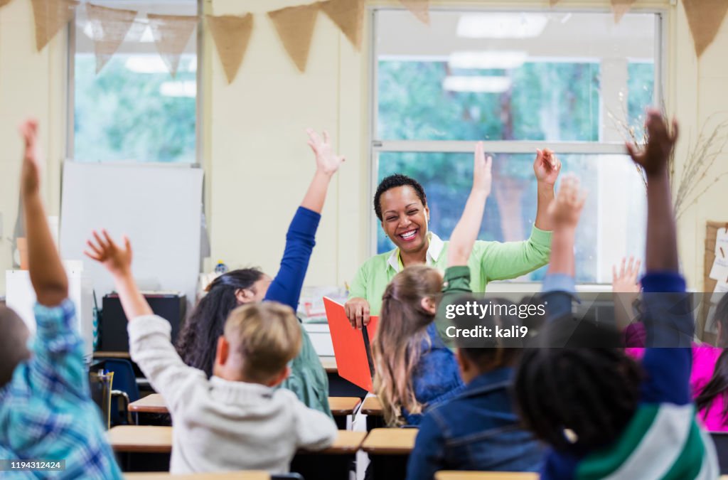African-American teacher reading to school children