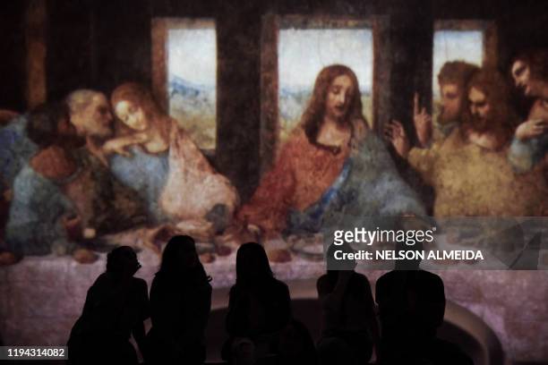 Visitors watch the multimedia installation during the "Leonardo da Vinci - 500 years of a genius" exhibition at the Museu da Imagem e do Som , in Sao...