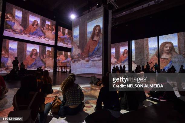 Visitors watch the multimedia installation during the "Leonardo da Vinci - 500 years of a genius" exhibition at the Museu da Imagem e do Som , in Sao...