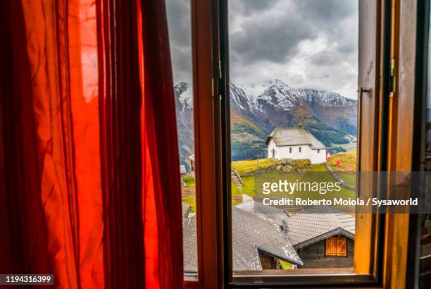 bettmeralp alpine village view through window, valais, switzerland - rhone stock pictures, royalty-free photos & images