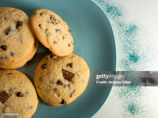 chocolate cookies arranged on a plate with sequins - shortbread stock pictures, royalty-free photos & images