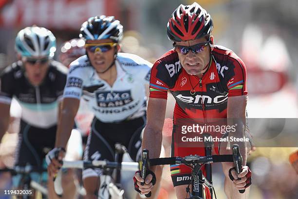 Cadel Evans of Australia and BMC Racing Team crosses the finishing line alongside Alberto Contador of Spain and Saxo Bank Sungard and Andy Schleck of...
