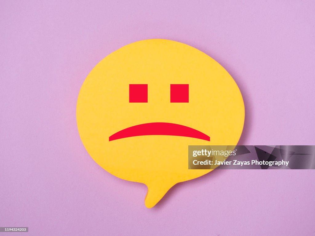 Note In The Shape Of Comic Bubbles With Sad Face Emoji