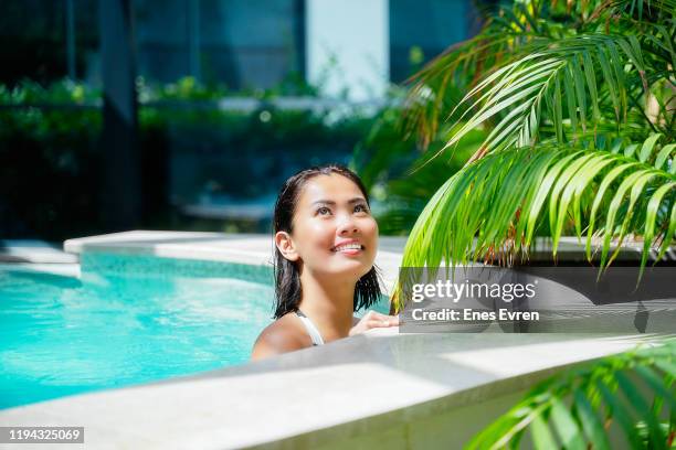 asian woman in hot tub pool enjoying at holiday resort - singapore spa stock pictures, royalty-free photos & images