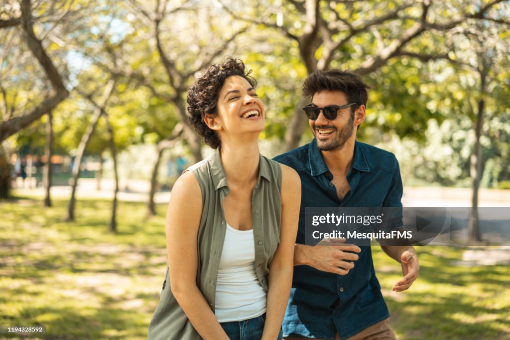 Young couple enjoying the sunny day at park