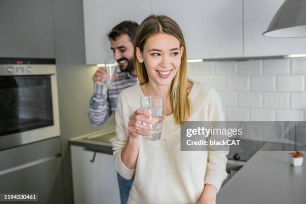 couple at home drinking water - cat drinking water stock pictures, royalty-free photos & images