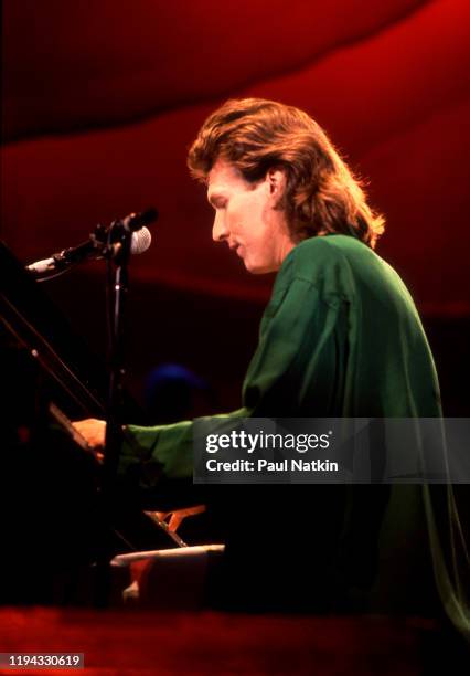 English Rock and Pop musician Steve Winwood plays keyboards as he performs onstage at the UIC Pavilion, Chicago, Illinois, November 7, 1986.