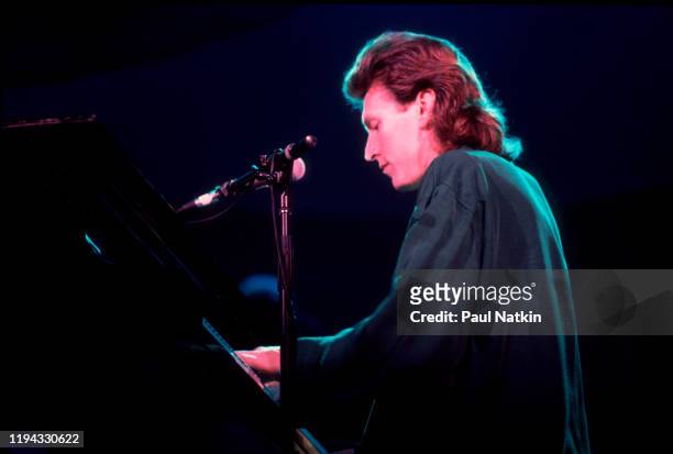 English Rock and Pop musician Steve Winwood plays keyboards as he performs onstage at the UIC Pavilion, Chicago, Illinois, November 7, 1986.
