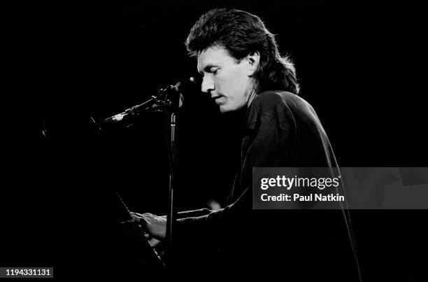 English Rock and Pop musician Steve Winwood plays keyboards as he performs onstage at the UIC Pavilion, Chicago, Illinois, November 7, 1986.
