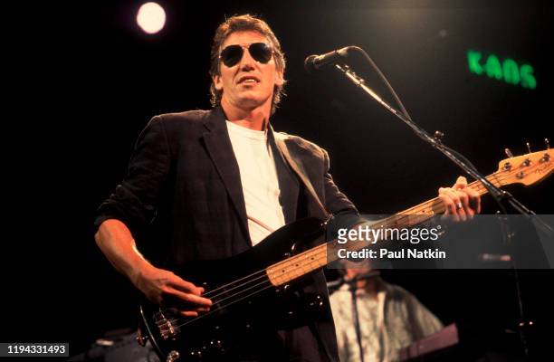 English Rock musician Roger Waters plays bass as he performs onstage at the Poplar Creek Music Theater, Hoffman Estates, Illinois, September 9, 1987.
