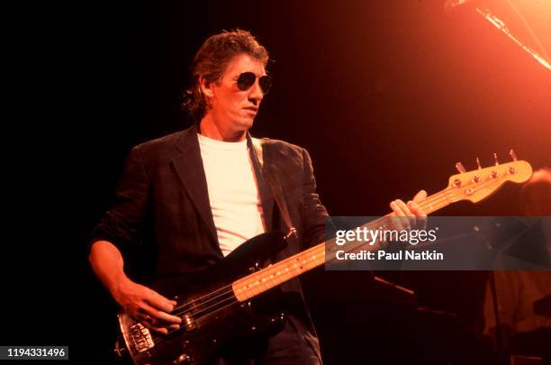 English Rock musician Roger Waters plays bass as he performs onstage at the Poplar Creek Music Theater, Hoffman Estates, Illinois, September 9, 1987.