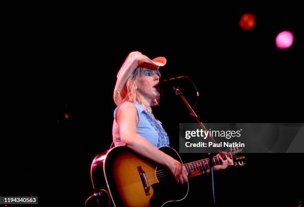 American Folk and Country musician Lucinda Williams plays guitar as she performs onstage at the Navy Pier's Skyline Stage, Chicago, Illinois, June...