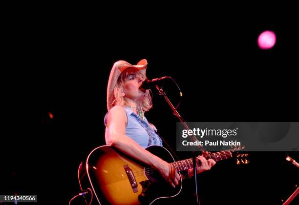 American Folk and Country musician Lucinda Williams plays guitar as she performs onstage at the Navy Pier's Skyline Stage, Chicago, Illinois, June...