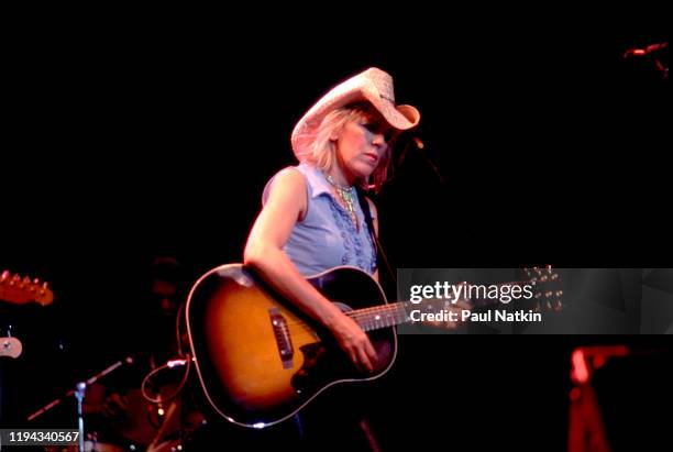 American Folk and Country musician Lucinda Williams plays guitar as she performs onstage at the Navy Pier's Skyline Stage, Chicago, Illinois, June...