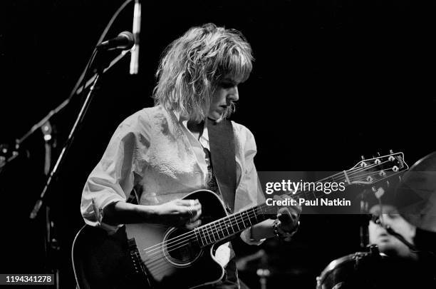 American Folk and Country musician Lucinda Williams plays guitar as she performs onstage at the Park West, Chicago, Illinois, September 20, 1992.