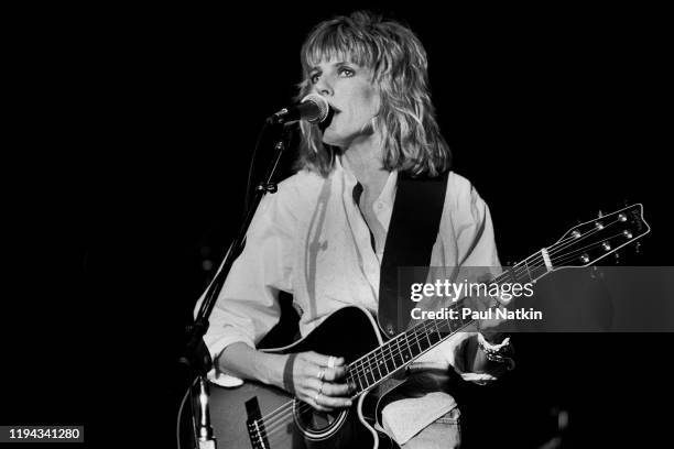 American Folk and Country musician Lucinda Williams plays guitar as she performs onstage at the Park West, Chicago, Illinois, September 20, 1992.