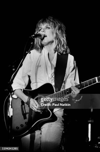 American Folk and Country musician Lucinda Williams plays guitar as she performs onstage at the Park West, Chicago, Illinois, September 20, 1992.