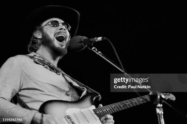 American Country musician Hank Williams Jr plays guitar as he performs onstage at an unspecified venue, Oakbrook, Illinois, November 27, 1977.
