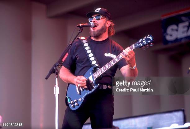 American Country musician Hank Williams Jr plays guitar as he performs onstage at the Petrillo Bandshell, Chicago, Illinois, June 25, 1996.