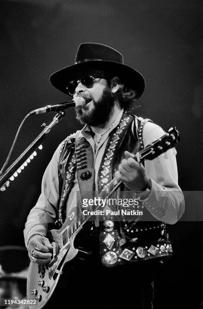 American Country musician Hank Williams Jr plays guitar as he performs onstage at an unspecified venue, Fresno, California, April 19, 1986.