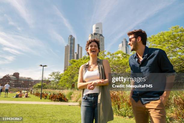 couple dating in the public park in puerto madero, buenos aires - buenos aires cityscape stock pictures, royalty-free photos & images