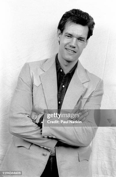 Portrait of American Country musician Randy Travis as he poses backstage at an unspecified nightclub, Dallas, Texas, December 13, 1986.