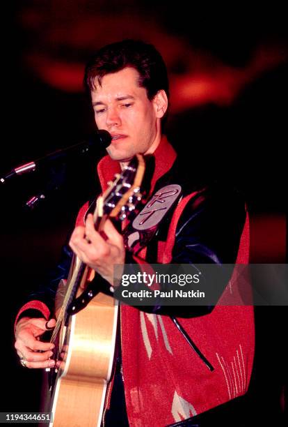 American Country musician Randy Travis plays guitar as he performs onstage at the Wisconsin State Fair, Milwaukee, Wisconsin, July 15, 1988.