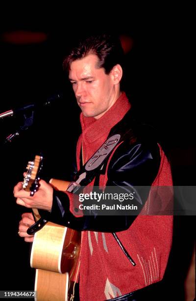 American Country musician Randy Travis plays guitar as he performs onstage at the Wisconsin State Fair, Milwaukee, Wisconsin, July 15, 1988.