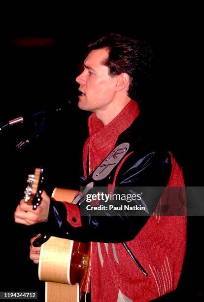 American Country musician Randy Travis plays guitar as he performs onstage at the Wisconsin State Fair, Milwaukee, Wisconsin, July 15, 1988.