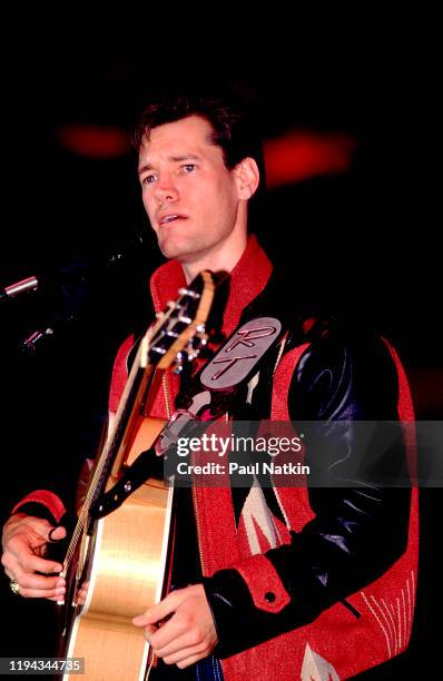 American Country musician Randy Travis plays guitar as he performs onstage at the Wisconsin State Fair, Milwaukee, Wisconsin, July 15, 1988.