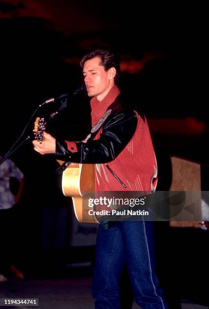 American Country musician Randy Travis plays guitar as he performs onstage at the Wisconsin State Fair, Milwaukee, Wisconsin, July 15, 1988.