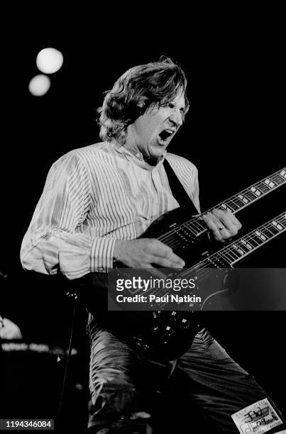 American Rock musician Joe Walsh plays guitar as he performs onstage during Chicagofest, Chicago, Illinois, August 21, 1983.
