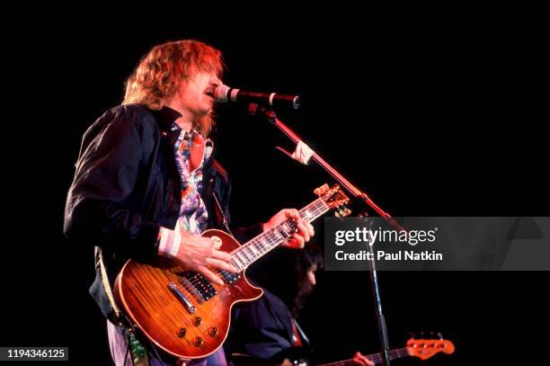 American Rock musician Joe Walsh plays guitar as he performs onstage at the Alpine Valley Music Theater, East Troy, Wisconsin, July 1, 1989.