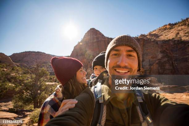a family taking a selfie while hiking a scenic trail - saint george fotografías e imágenes de stock