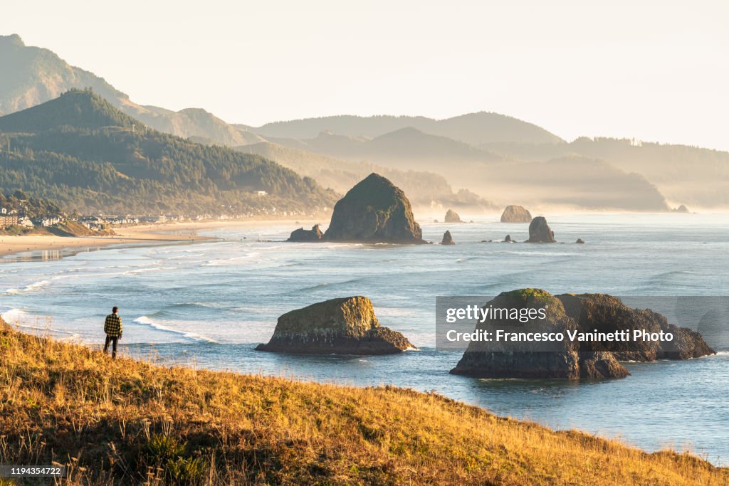 Man looking at view, Ecola State Park, Cannon Beach, Oregon, USA.