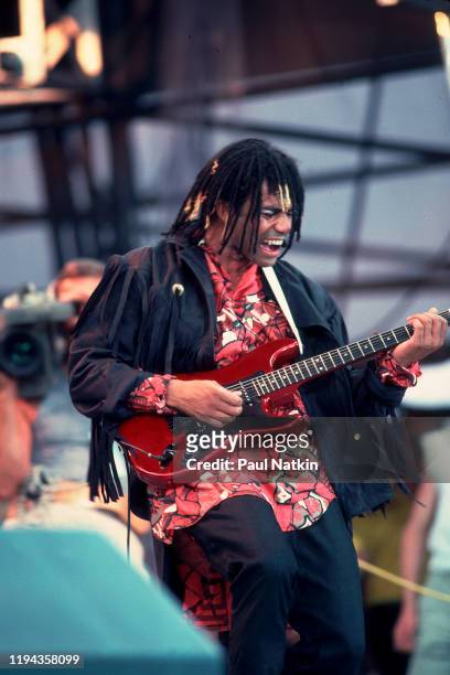 New Wave musician Joe Leeway, of the English group Thompson Twins, plays guitar as he performs onstage during the Live Aid benefit concert at John F...
