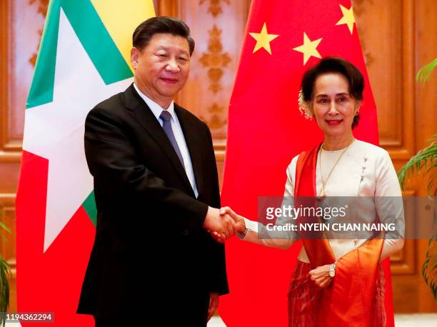 Chinese President Xi Jinping and Myanmar State Counsellor Aung San Suu Kyi shake hands before a bilateral meeting at the Presidential Palace in...