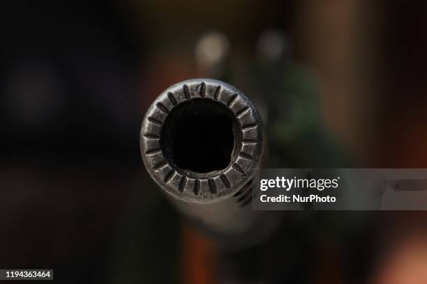 Gun barrel of an indian paramilitary trooper is seen as he stands alert at a makeshift bunker ahead of the India's Republic day and Delhi assembly...