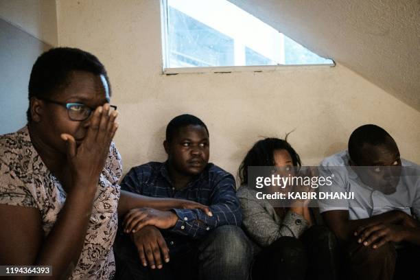 People wait to be evacuated after a bomb blast from the office block attached to DusitD2 hotel in Nairobi, Kenya, on January 15, 2019. - A huge blast...