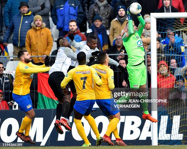 Epinal's goalkeeper Jerome Idir stops the ball during the French Cup football match between Epinal and Saint-Pierroise on January 18 at La Colombiere...