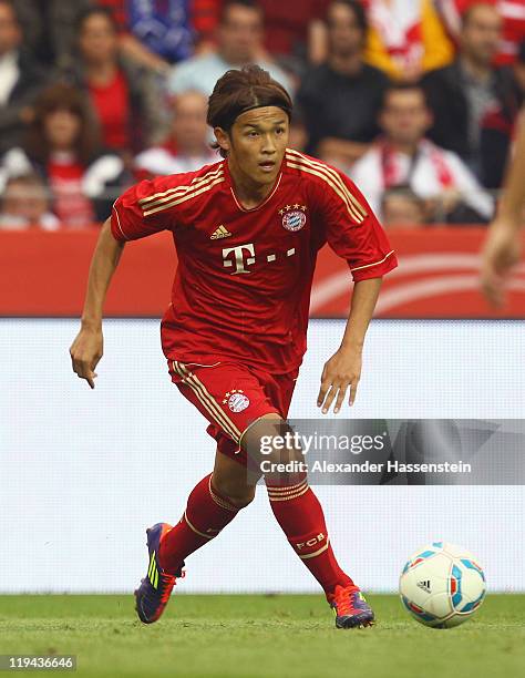 Takashi Usami of Muenchen runs with the ball during the LIGA total! Cup 3rd place match between FSV Mainz 05 and Bayern Muenchen at Coface Arena on...