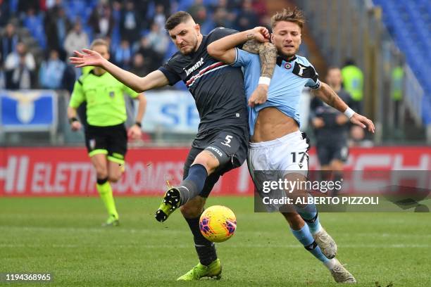 Sampdoria's German defender Julian Chabot and Lazio's Italian forward Ciro Immobile go for the ball during the Italian Serie A football match Lazio...