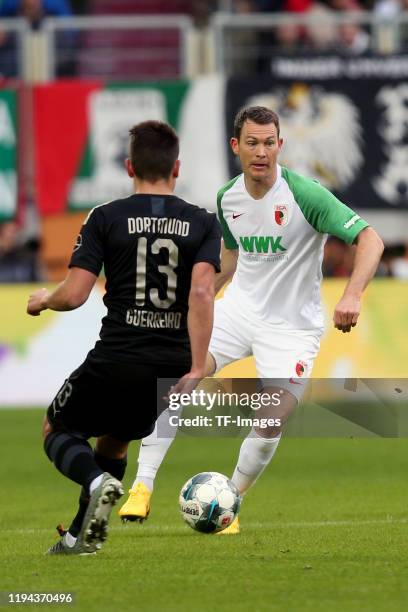 IAUGSBURG, GERMANY Raphael Guerreiro of Borussia Dortmund and Stephan Lichtsteiner of FC Augsburg battle for the ball during the Bundesliga match...